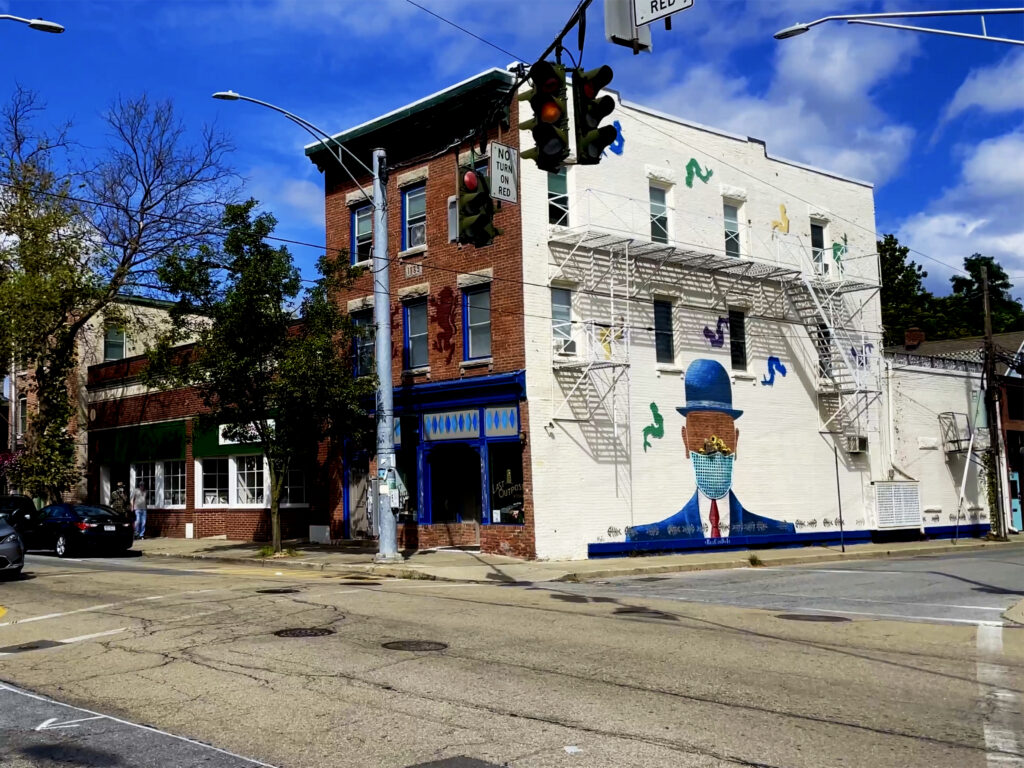 A brick building on Main St. in Beacon, NY with a mural on the side.