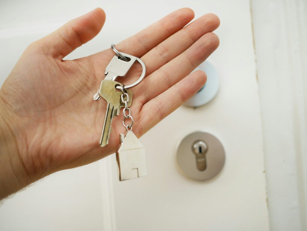 Hand holding keys to a new home.