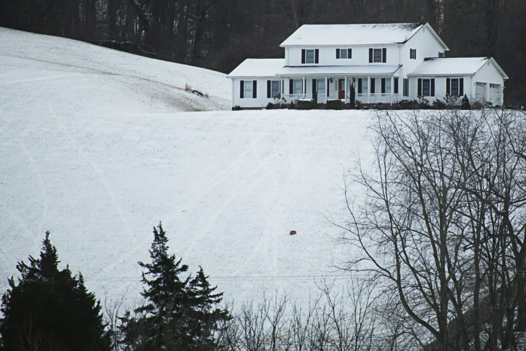 Snow covered house in the woods.