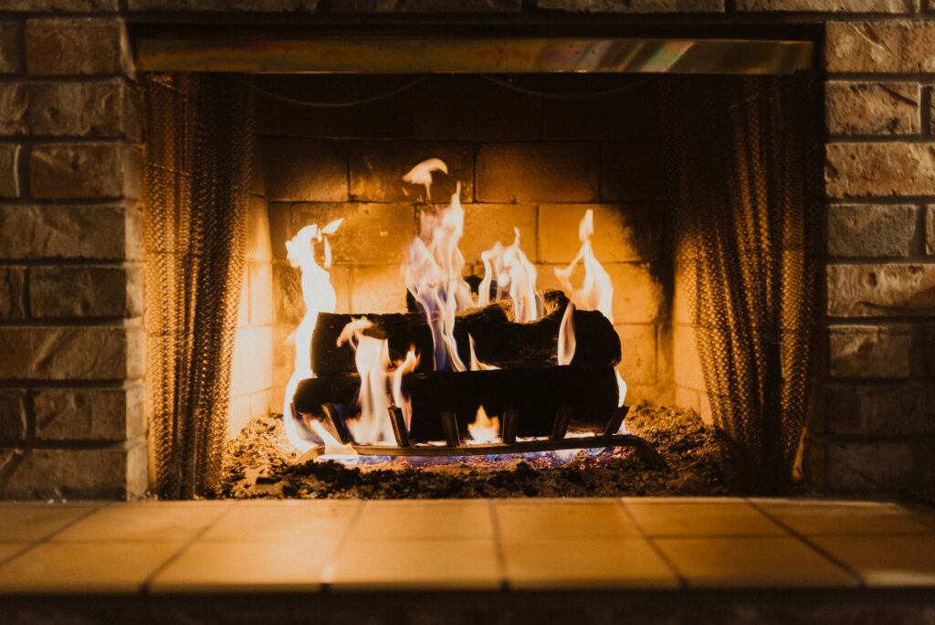 A fireplace with a roaring fire.